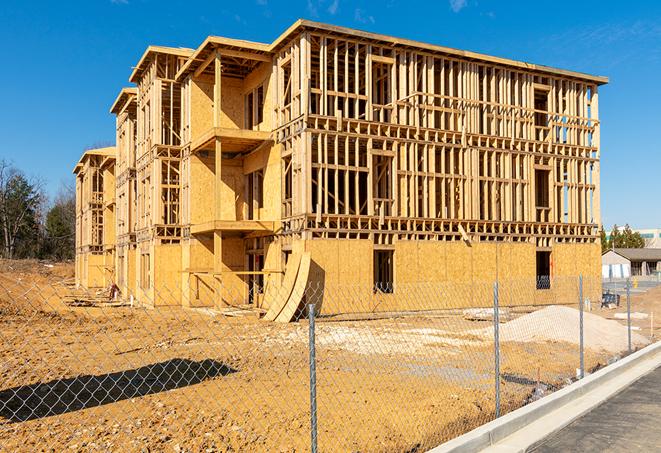 a close-up of temporary chain link fences enclosing a construction site, signaling progress in the project's development in Burlington